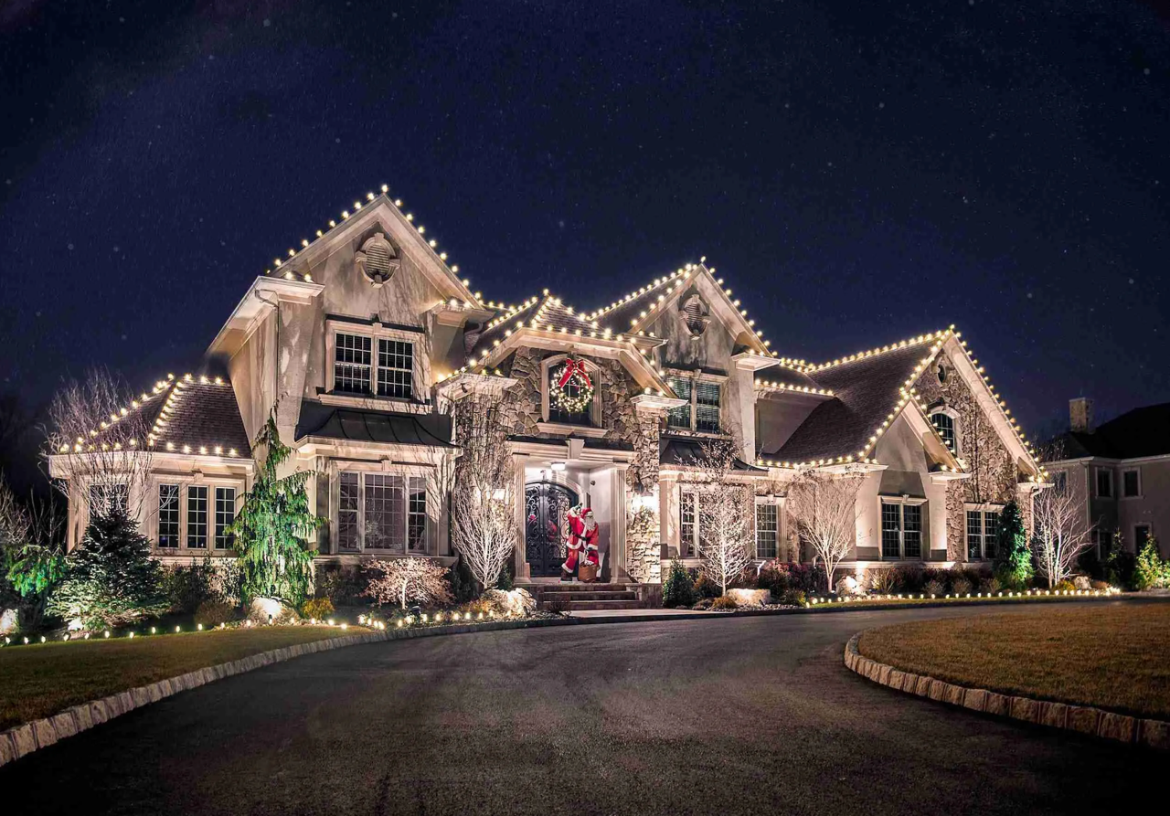Luxury Miami Valley home at night with professional holiday and roofline lighting